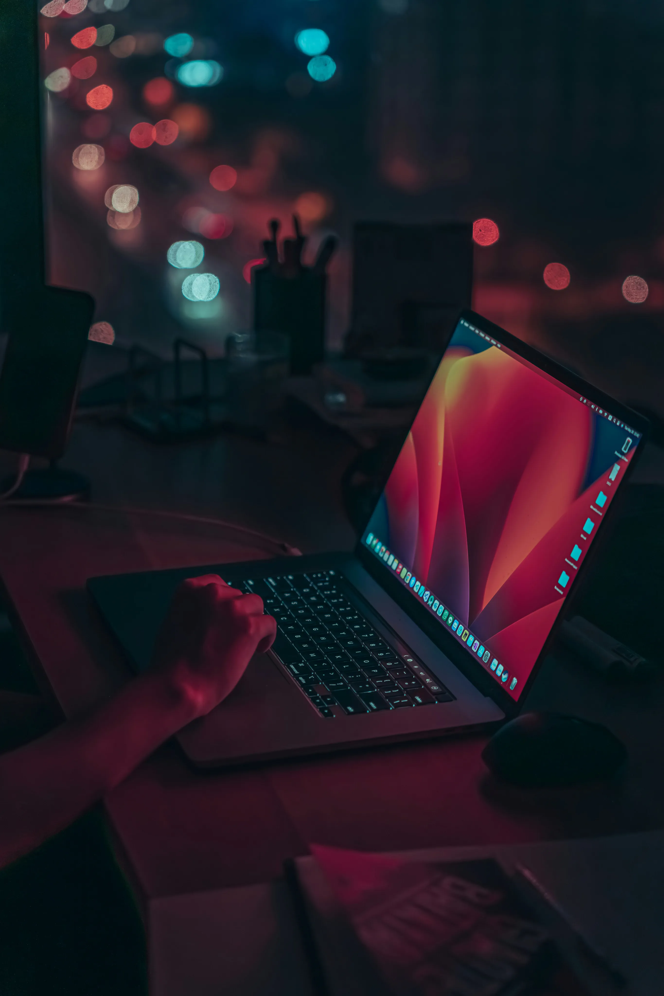A person working at a laptop at night